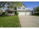 Charming two-story home featuring a welcoming porch and a three car attached garage at 11458 Falling Water Way, Fishers, IN 46037