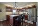 Kitchen featuring stainless steel appliances, island, and hardwood floors at 11458 Falling Water Way, Fishers, IN 46037