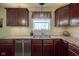 Kitchen sink with stainless steel appliances, window view, and ample counter space at 11458 Falling Water Way, Fishers, IN 46037