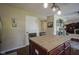 Bright kitchen island with butcher block top and pendant lighting offers additional seating at 11458 Falling Water Way, Fishers, IN 46037