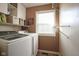 Well-lit laundry room with modern washer and dryer and ample storage space at 11458 Falling Water Way, Fishers, IN 46037