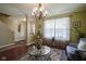 Inviting living room featuring hardwood floors, a glass table and comfortable furniture at 11458 Falling Water Way, Fishers, IN 46037