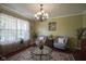 Comfortable living room with a round table, patterned rug and lots of natural light from the window at 11458 Falling Water Way, Fishers, IN 46037