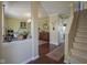 Open-concept living space with hardwood floors, crown molding and staircase to the right at 11458 Falling Water Way, Fishers, IN 46037