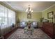 Bright and airy living room featuring elegant furniture and a view of the landscaped front yard at 11458 Falling Water Way, Fishers, IN 46037