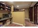 Bright basement office with built-in shelving and wood flooring at 11458 Falling Water Way, Fishers, IN 46037