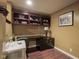 Basement office with built-in shelving, modern desk, and ample natural light at 11458 Falling Water Way, Fishers, IN 46037