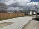 Gravel backyard with a new wooden fence between properties at 117 N 10Th St, Elwood, IN 46036