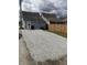 Recently graveled backyard featuring a new wooden fence and detached garage at 117 N 10Th St, Elwood, IN 46036
