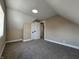Angled ceiling bedroom with soft carpet and natural light filtering through the window at 117 N 10Th St, Elwood, IN 46036
