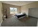 Cozy bedroom with neutral walls, plush carpeting, and bright natural light from the window at 117 N 10Th St, Elwood, IN 46036
