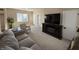 Open-concept living room with comfortable seating, fireplace and large screen tv for entertainment at 117 N 10Th St, Elwood, IN 46036