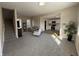 Spacious living room with neutral tones, plush carpet, and ample natural light from large windows at 117 N 10Th St, Elwood, IN 46036