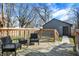 Back deck with chairs and wooden railing, offering an outdoor seating area at 1209 N Rural St, Indianapolis, IN 46201