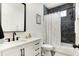 Bright bathroom featuring a vanity, toilet and tiled tub and shower with decorative curtain at 1209 N Rural St, Indianapolis, IN 46201