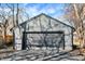 Exterior view of a gray garage with a dark garage door and a freshly paved driveway at 1209 N Rural St, Indianapolis, IN 46201