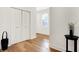 Bright hallway with hardwood floors, closet doors, and natural light at 1209 N Rural St, Indianapolis, IN 46201