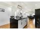 Open-concept kitchen with a center island, white cabinets, and an adjacent dining and living area at 1209 N Rural St, Indianapolis, IN 46201