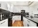 Bright kitchen features black countertops, a herringbone backsplash, and stainless steel appliances at 1209 N Rural St, Indianapolis, IN 46201