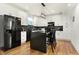 Well-lit kitchen featuring a black island, white cabinetry, and stainless steel appliances at 1209 N Rural St, Indianapolis, IN 46201