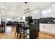 Bright kitchen features an island, black countertops, herringbone backsplash, and stainless steel appliances at 1209 N Rural St, Indianapolis, IN 46201