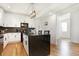 Contemporary kitchen boasts a black island, white cabinets, stainless appliances, and wood floors at 1209 N Rural St, Indianapolis, IN 46201