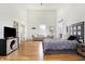 Bright bedroom features a high vaulted ceiling, wood floors, and neutral décor at 1209 N Rural St, Indianapolis, IN 46201