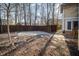 Backyard features a stone patio area, mature trees, and a wood fence at 12348 Seaway Cir, Indianapolis, IN 46236