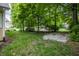 Backyard with mature trees and lush green grass at 12348 Seaway Cir, Indianapolis, IN 46236