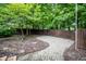 A secluded patio area surrounded by mature trees and lush greenery at 12348 Seaway Cir, Indianapolis, IN 46236