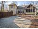 Yellow home featuring a brick patio, screened porch, and landscaped backyard at 12348 Seaway Cir, Indianapolis, IN 46236