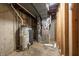 Unfinished basement area with water heater, furnace, and exposed ductwork at 12348 Seaway Cir, Indianapolis, IN 46236