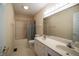 Bathroom featuring double sinks, generous vanity, and shower-tub combination with neutral tile at 12348 Seaway Cir, Indianapolis, IN 46236