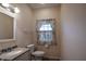 Well-lit powder room featuring granite countertop, stylish fixtures, and window at 12348 Seaway Cir, Indianapolis, IN 46236