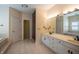 Bright bathroom featuring double sinks, a large mirror, walk-in shower, and tub at 12348 Seaway Cir, Indianapolis, IN 46236