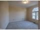 Bedroom featuring neutral carpet and a large arched window at 12348 Seaway Cir, Indianapolis, IN 46236