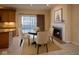 Cozy breakfast nook with fireplace, sliding glass doors, and round table offers inviting dining space at 12348 Seaway Cir, Indianapolis, IN 46236