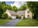 Charming yellow brick home with lush green landscaping and an inviting driveway at 12348 Seaway Cir, Indianapolis, IN 46236