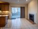 Open kitchen and dining area with granite countertops, tile floors, and a fireplace at 12348 Seaway Cir, Indianapolis, IN 46236