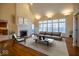 Bright living room featuring a fireplace, large windows, and hardwood floors at 12348 Seaway Cir, Indianapolis, IN 46236