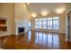 Bright living room with fireplace, hardwood floors, and large windows at 12348 Seaway Cir, Indianapolis, IN 46236