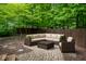 Outdoor patio seating area with wicker sectional, chair, and privacy fence at 12348 Seaway Cir, Indianapolis, IN 46236