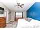 Bright bedroom featuring a ceiling fan, wood-look floors, and a large window at 1269 Frogs Leap, Cicero, IN 46034