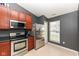 Modern kitchen with stainless steel appliances, tile flooring, and dark wood cabinets at 1269 Frogs Leap, Cicero, IN 46034