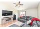 Inviting living room with ceiling fan, hardwood floors, a sectional sofa, and a modern entertainment center at 1269 Frogs Leap, Cicero, IN 46034