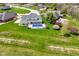 Aerial view of home showcasing in-ground pool, well-manicured lawn, and neighboring houses in a suburban setting at 1358 Rutherglen Ct, Danville, IN 46122
