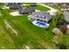 An amazing shot of a private in-ground pool, basketball court, and expansive green property at 1358 Rutherglen Ct, Danville, IN 46122