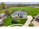 A stunning, expansive home boasts manicured lawns and a basketball court in a lush setting at 1358 Rutherglen Ct, Danville, IN 46122