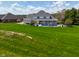 Backyard view of a home featuring in-ground pool, covered patio, and fenced yard, perfect for outdoor enjoyment at 1358 Rutherglen Ct, Danville, IN 46122