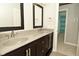 Stylish bathroom featuring a double vanity, with dark wood cabinets and modern fixtures at 1358 Rutherglen Ct, Danville, IN 46122